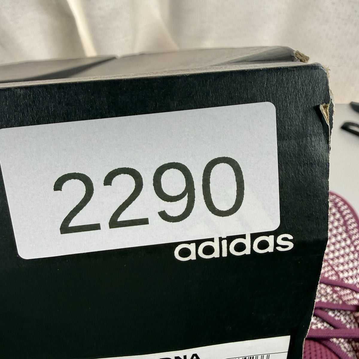 Adidas UltraBoost 1.0 DNA red trainers with signature three stripes and knit upper.