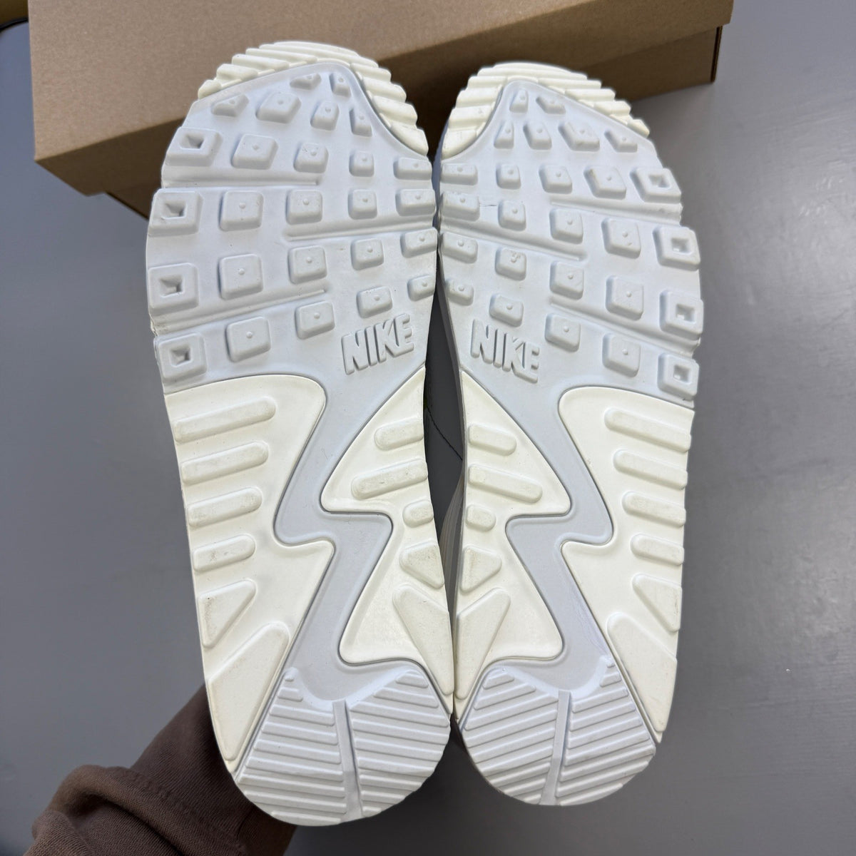 Nike white trainers with lemon venom accents and Air Max logo detail.