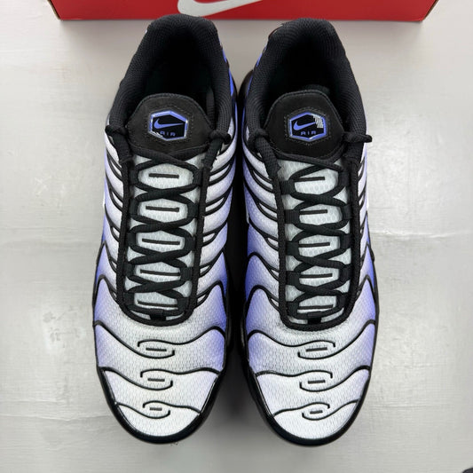 Nike Air Max Plus TN black trainers with sapphire blue accents and signature logo.