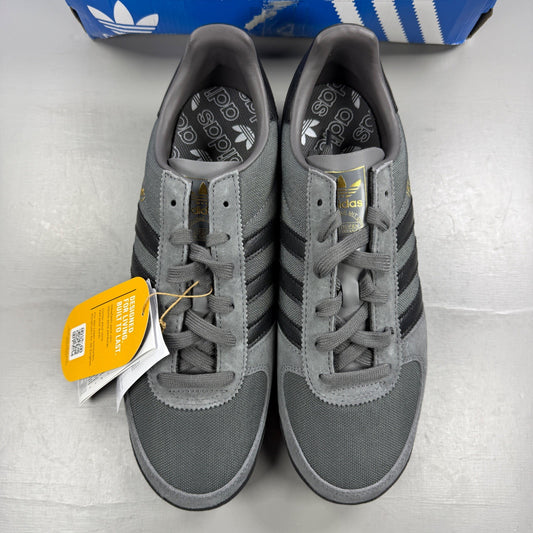 Adidas grey skate shoes with black accents and logo detail on tongue.