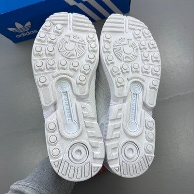 Adidas deck shoes white with minimalist design and iconic three stripes logo.