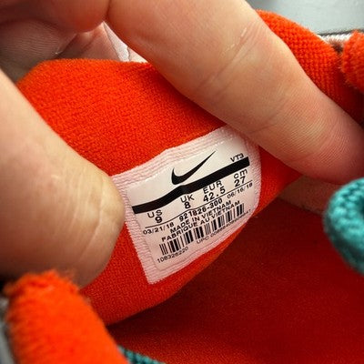 Nike trainers orange with rainforest accents and Air Max cushioning design.