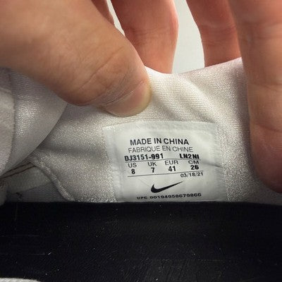 Nike trainers white with black snakeskin pattern and logo detail.