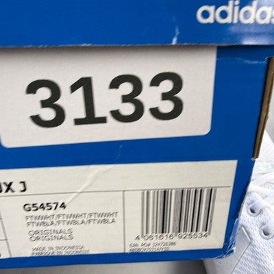 Adidas deck shoes white with minimalist design and iconic three stripes logo.