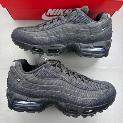 Nike black trainers with grey accents and iconic Air Max bubble sole.