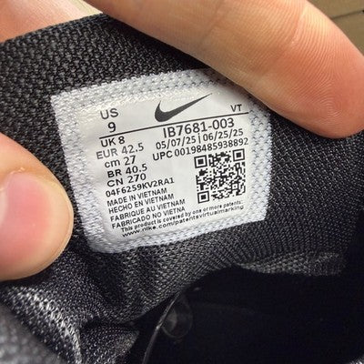 Nike Air Max trainers black and light grey with iconic logo and textured material.