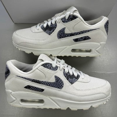 Nike trainers white with black snakeskin pattern and logo detail.