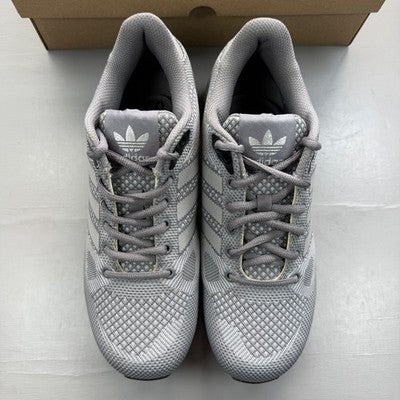 Adidas grey trainers with woven texture and signature three stripes logo.