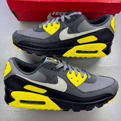 Nike trainers grey with yellow accents, featuring Air Max cushioning and logo detail.