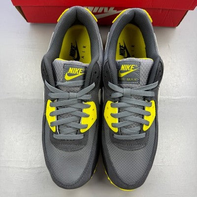 Nike trainers grey with yellow accents, featuring Air Max cushioning and logo detail.