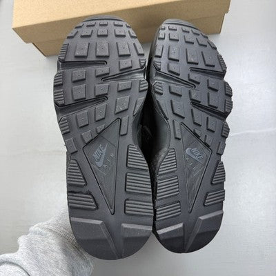 Nike black trainers with Huarache design and textured upper, featuring logo details.