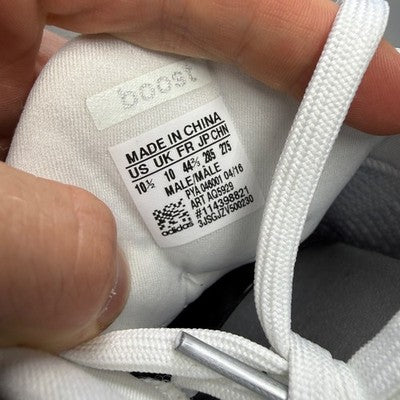 Adidas white trainers with mesh upper and Boost cushioning technology.