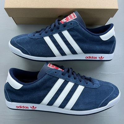 Adidas Originals navy suede trainers with white stripes and logo detailing.