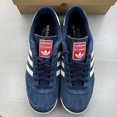 Adidas Originals navy suede trainers with white stripes and logo detailing.