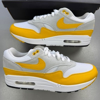 Nike trainers white with university gold accents and Air Max logo.