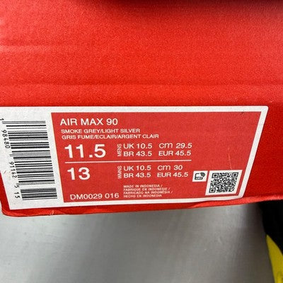 Nike trainers grey with yellow accents, featuring Air Max cushioning and logo detail.
