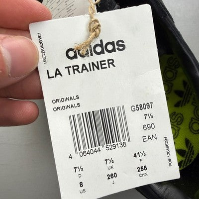 Adidas Originals black and yellow trainers with iconic three stripes and cushioned sole.