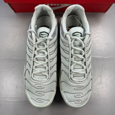 Nike Air Max trainers light silver with distinctive air cushioning and sleek design.