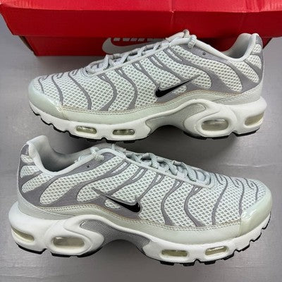 Nike Air Max trainers light silver with distinctive air cushioning and sleek design.