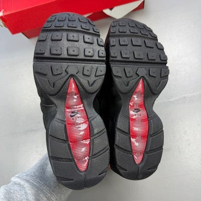 Nike Air Max 95 black red trainers with signature logo and mesh detailing.