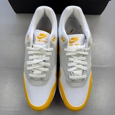 Nike trainers white with university gold accents and Air Max logo.