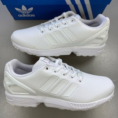 Adidas deck shoes white with minimalist design and iconic three stripes logo.