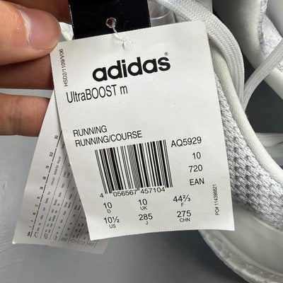 Adidas white trainers with mesh upper and Boost cushioning technology.