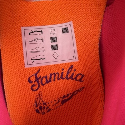 Nike trainers pink with Día De Muertos pattern and embroidered logo details.