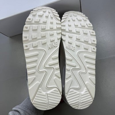 Nike trainers white with black snakeskin pattern and logo detail.