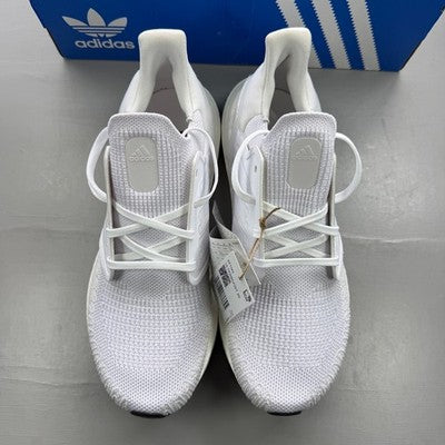Adidas white trainers with mesh upper and signature three stripes logo.