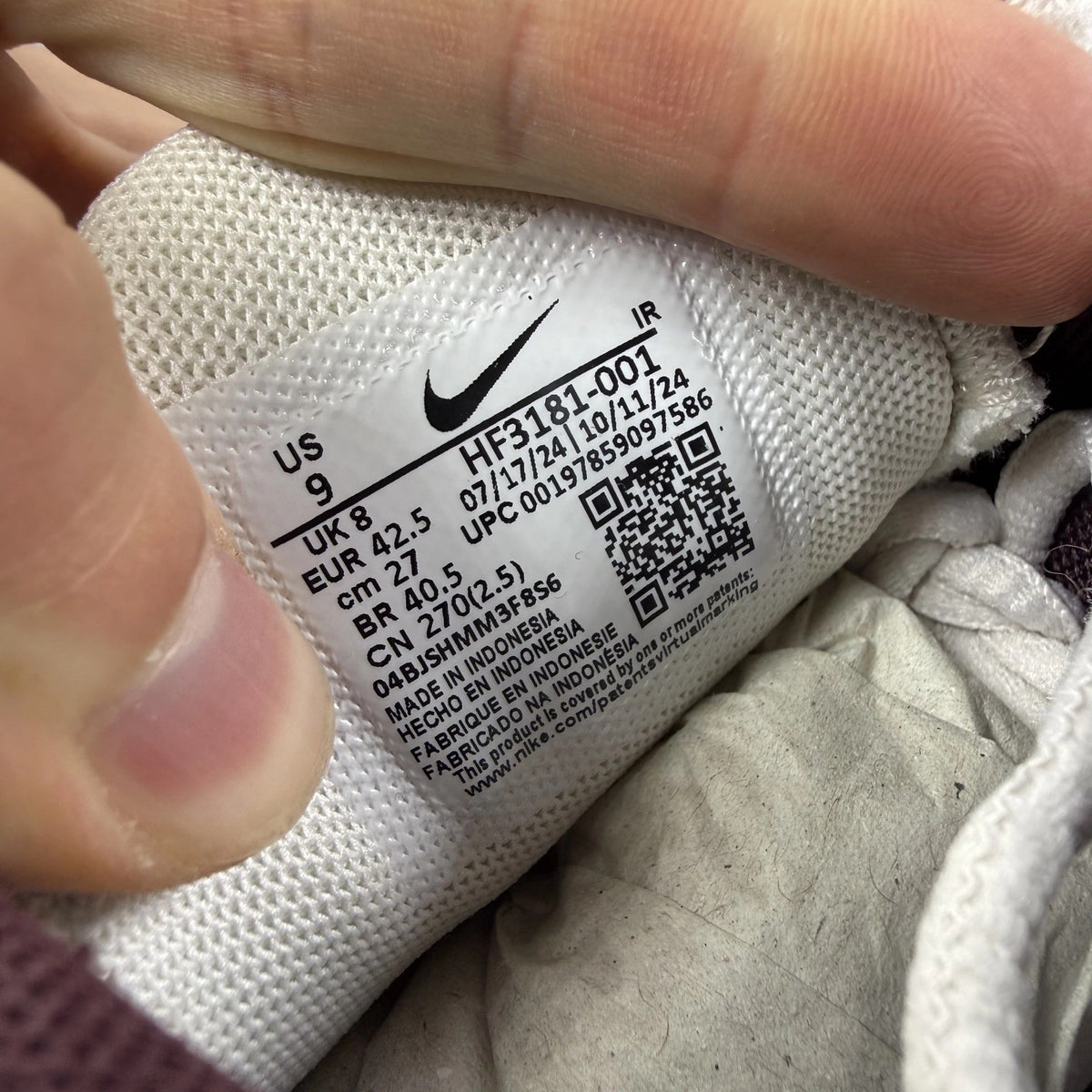 Nike Air Max Plus trainers white with burgundy accents and signature logo details.