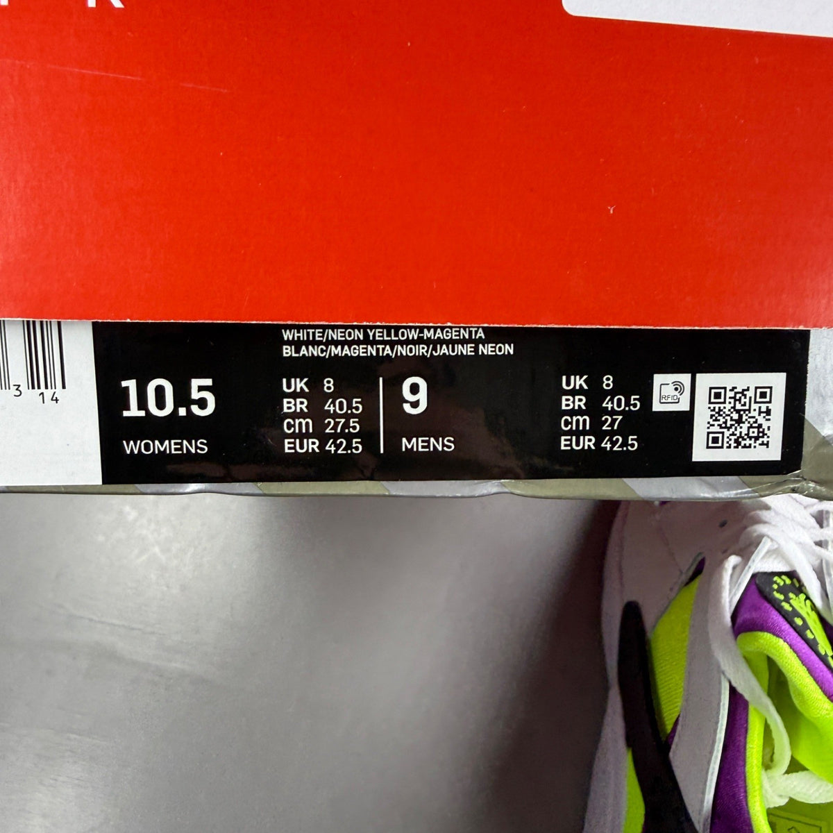 Nike white trainers with magenta neon accents and signature logo details.