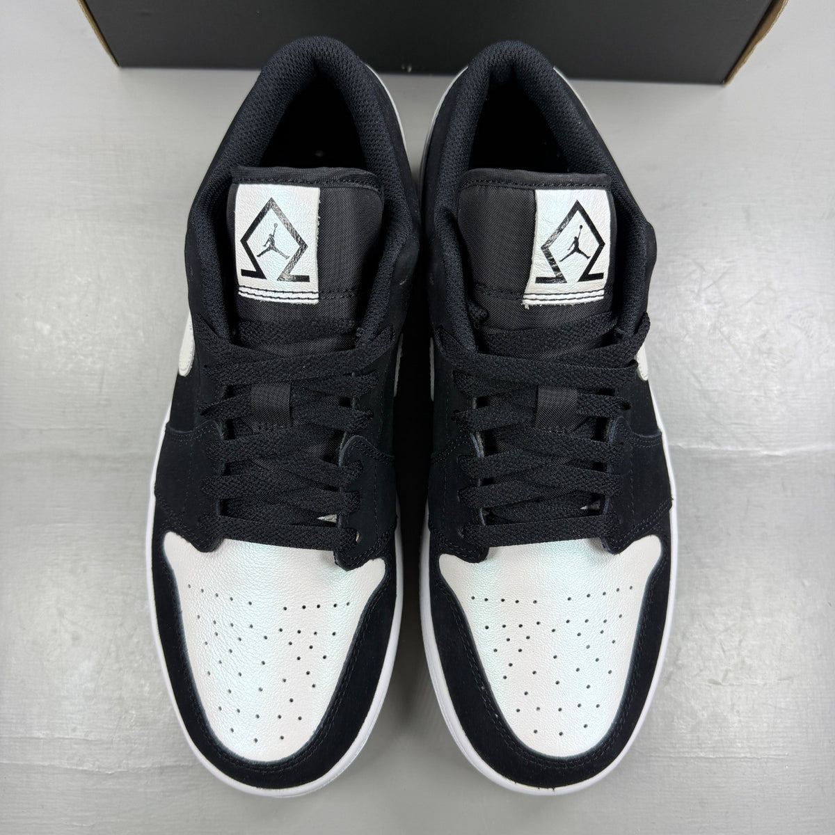 Jordan black athletic shoes with white accents and diamond pattern details.