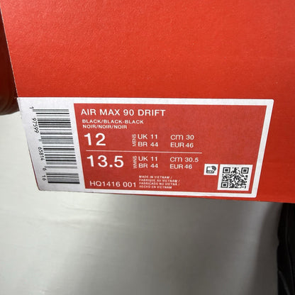 Nike Air Max 90 Drift black trainers with textured upper and signature logo.