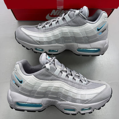 Nike trainers grey with aqua accents and retro logo detailing.