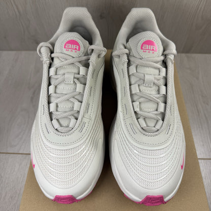 Nike Air Max trainers beige with pink accents and logo detail on the side.