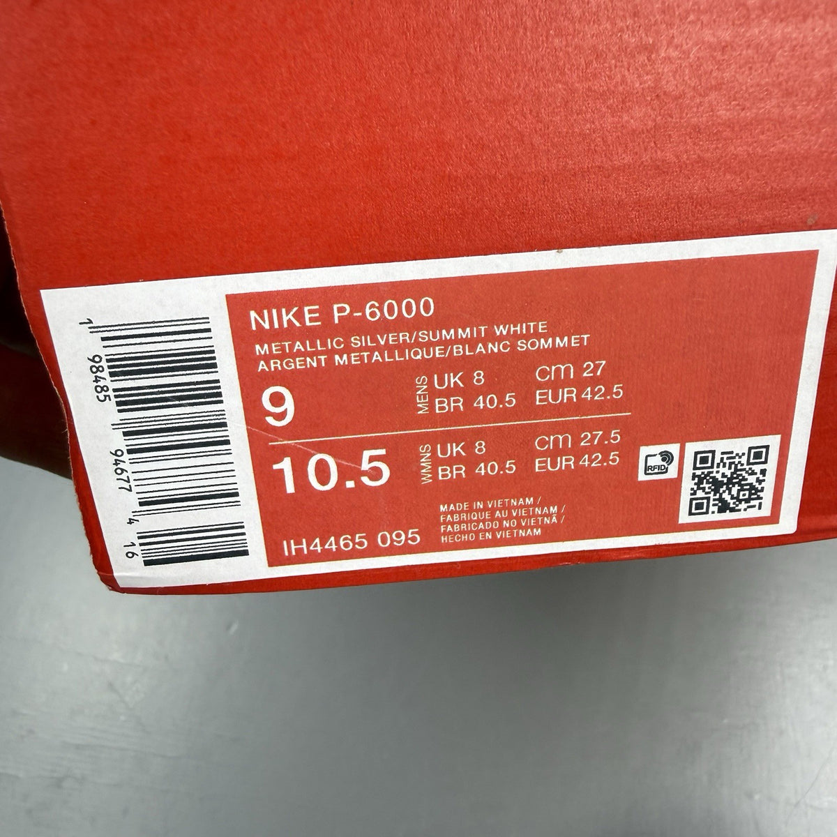 Nike P-6000 trainers metallic silver with white and grey accents, mesh material.