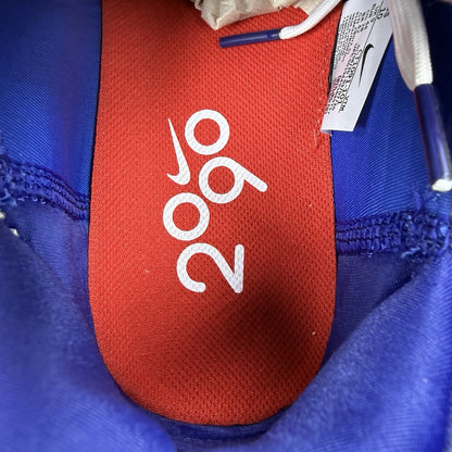 Nike Air Max 2090 trainers white with red and blue accents, featuring logo details.