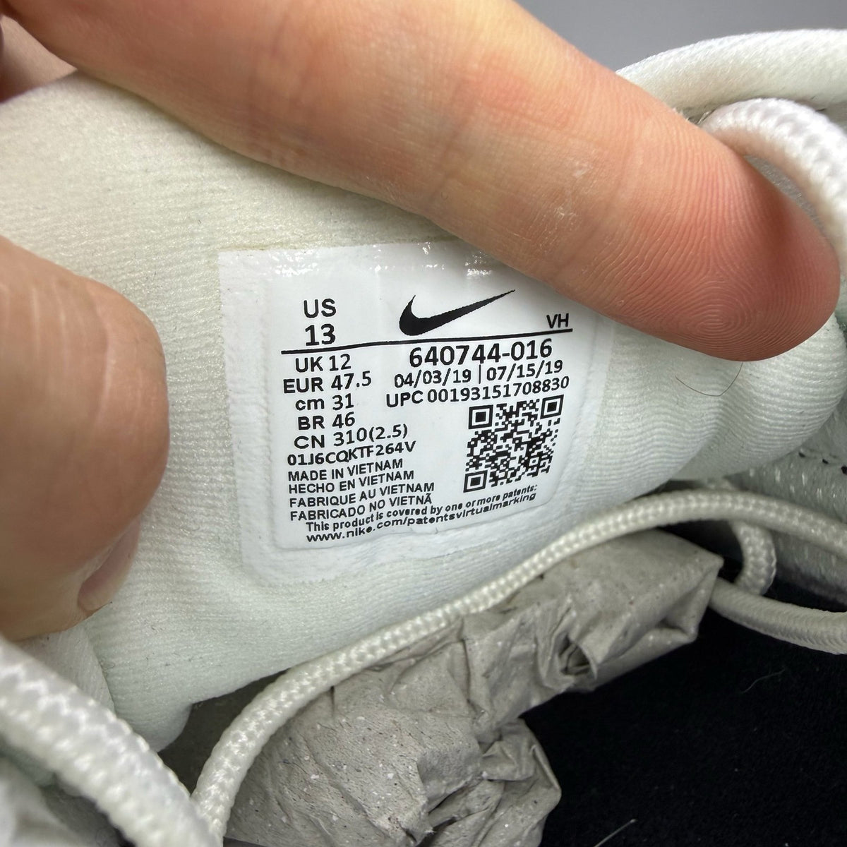 Nike Air Max 98 white trainers with black and yellow accents, featuring a sleek design.