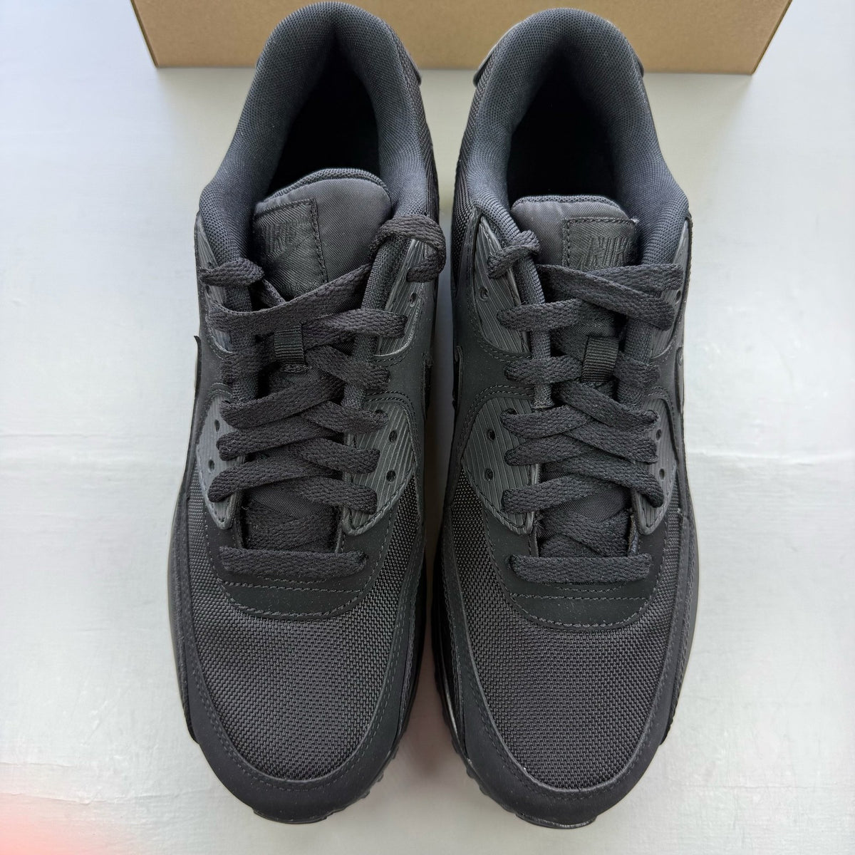 Nike black trainers with iconic Air Max cushioning and sleek design.
