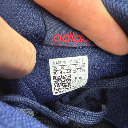 Adidas blue athletic shoes with white accents and ZX Flux logo details.