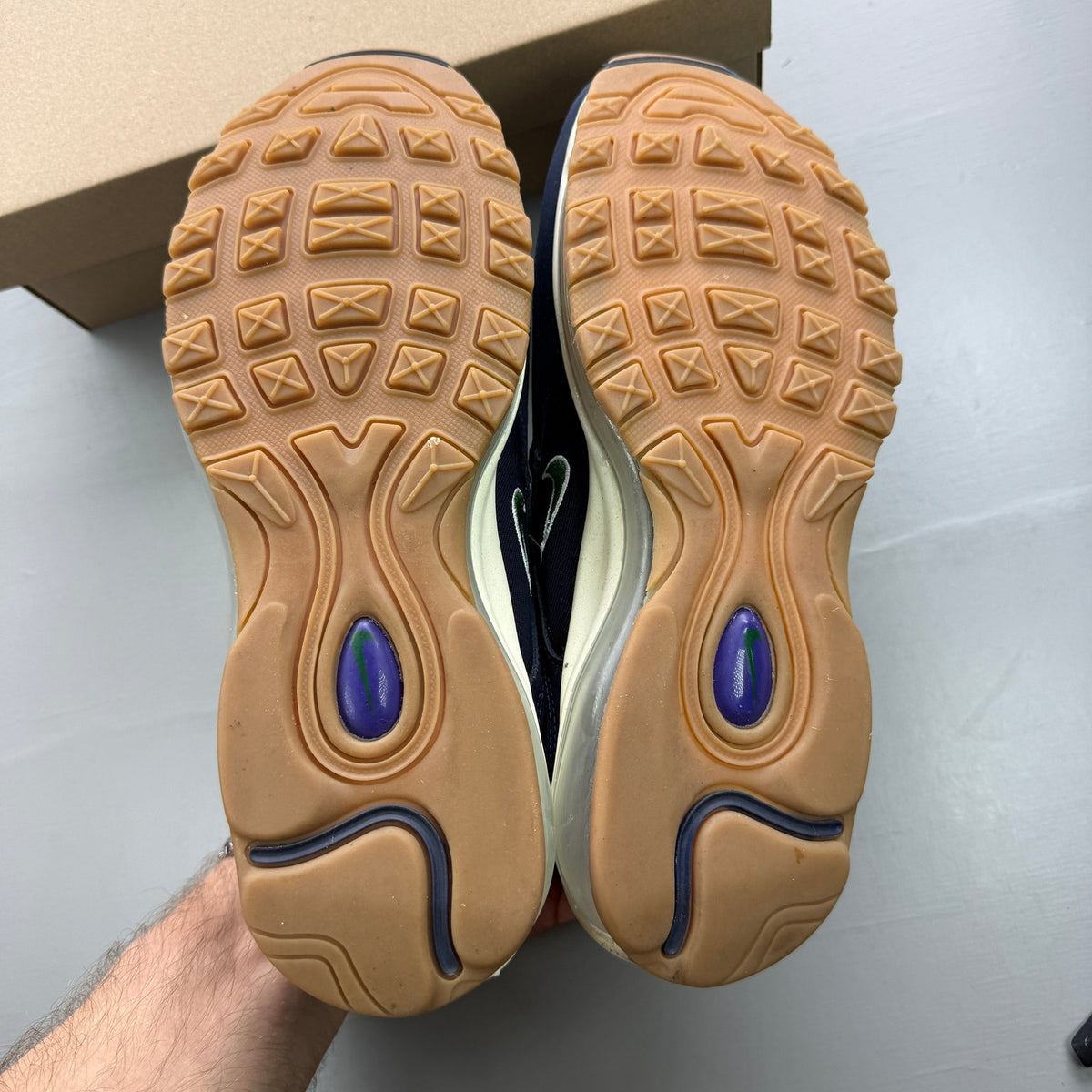 Nike Air Max 97 blue trainers with obsidian and gorge green accents, mesh and leather material.