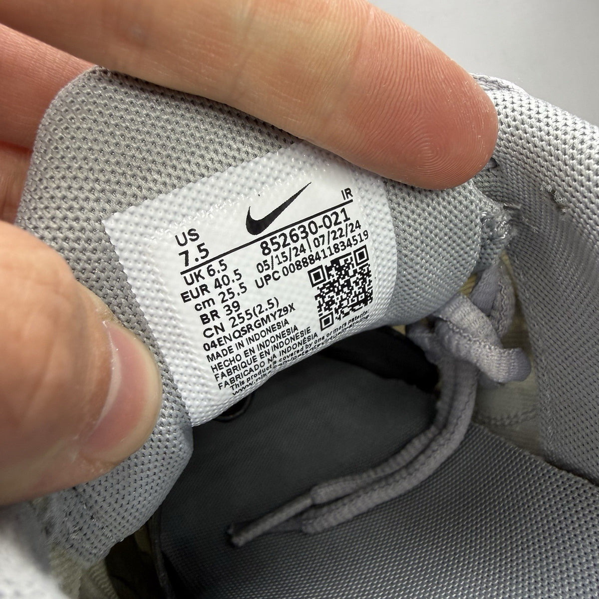 Nike Air Max Plus TN grey trainers mismatched sizes with distinctive logo and sleek design.