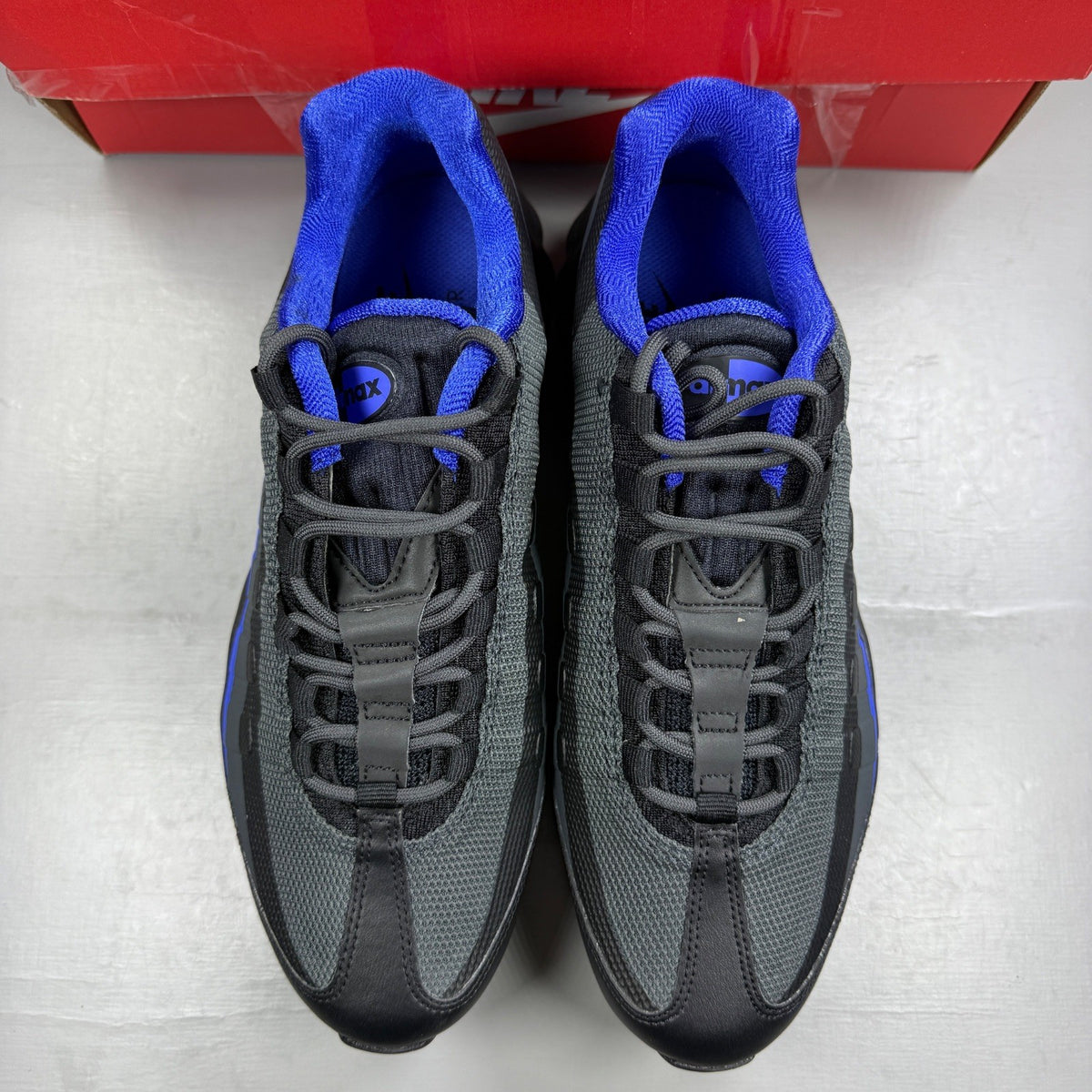 Nike Air Max 95 Ultra black trainers with blue accents and mesh upper.