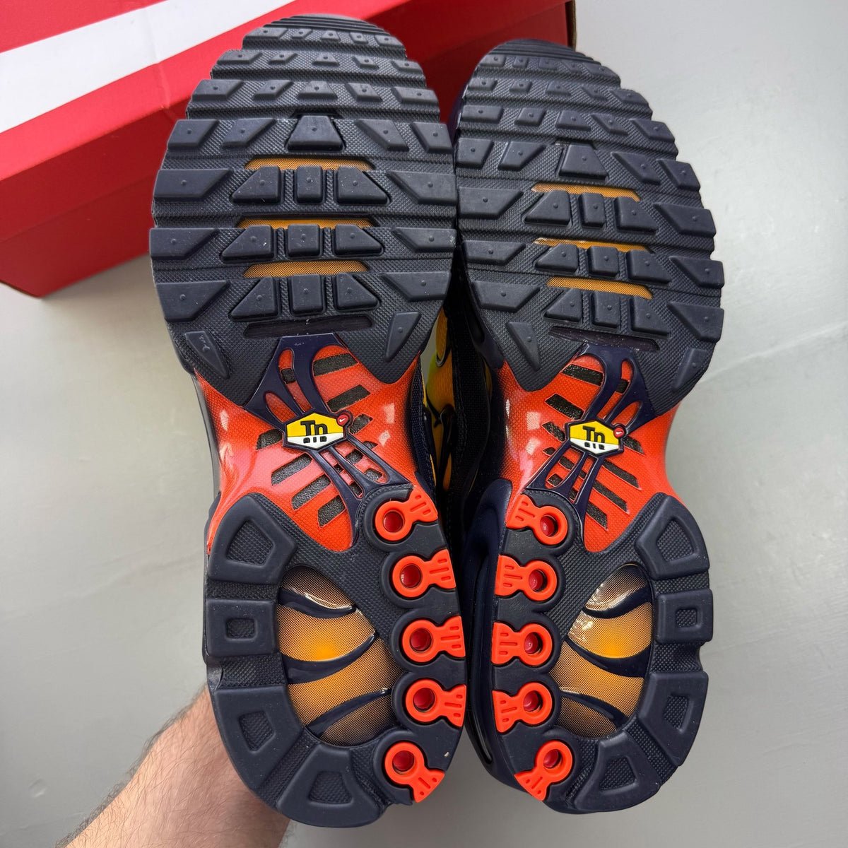 Nike Air Max Plus trainers yellow with Hyper Crimson accents and iconic TN logo.