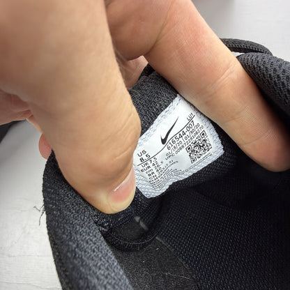 Nike black trainers with metallic silver accents and grey detailing, featuring logo on tongue.