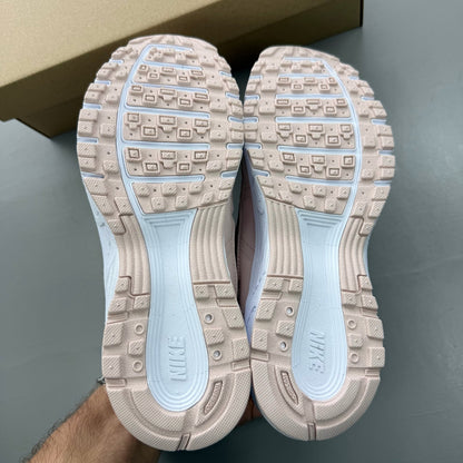 Nike P-6000 pink trainers with mesh upper and logo detailing.