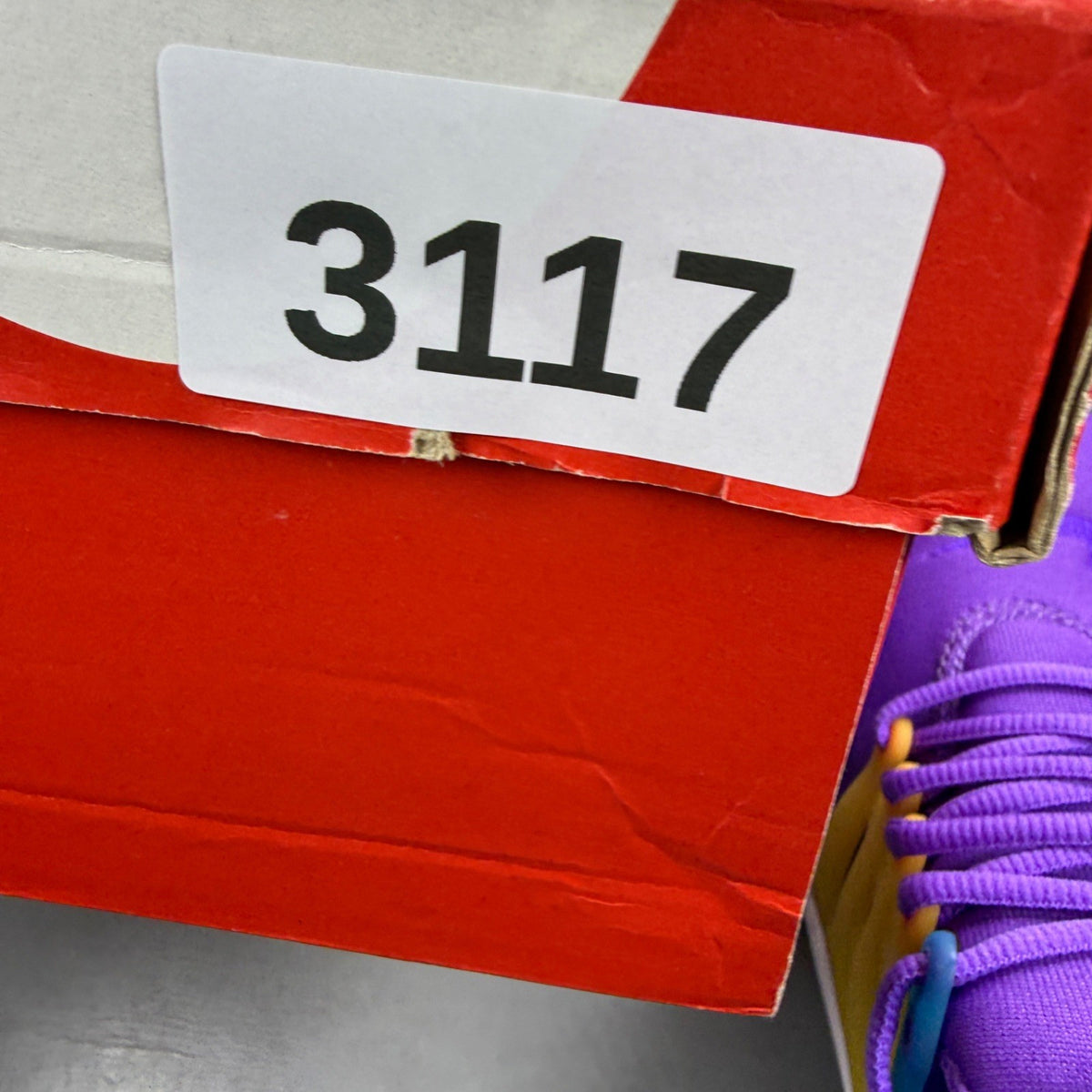 Nike Air Presto purple trainers with mesh upper and distinctive logo detailing.