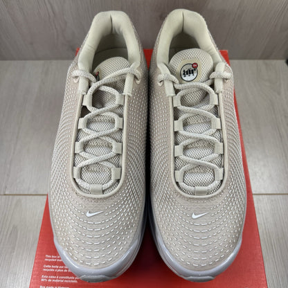 Nike Air Max DN trainers white with light brown accents and logo detail.