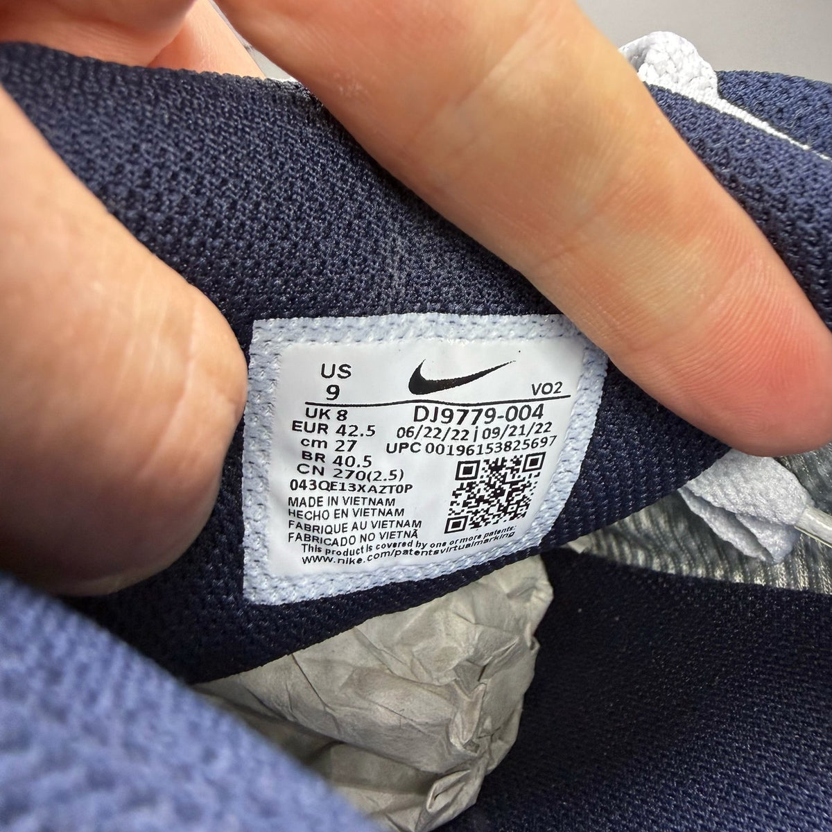 Nike Air Max 90 grey trainers with GORE-TEX material and logo detailing.